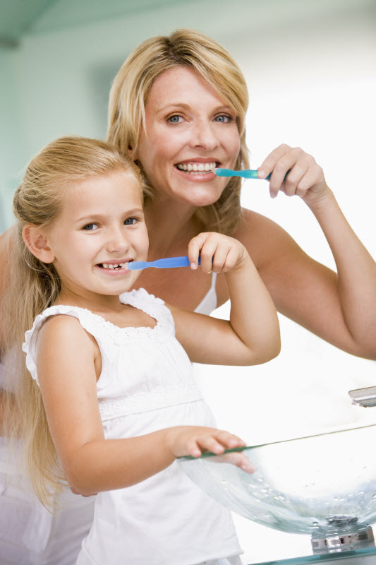 Mom and Daughter brushing their teeth